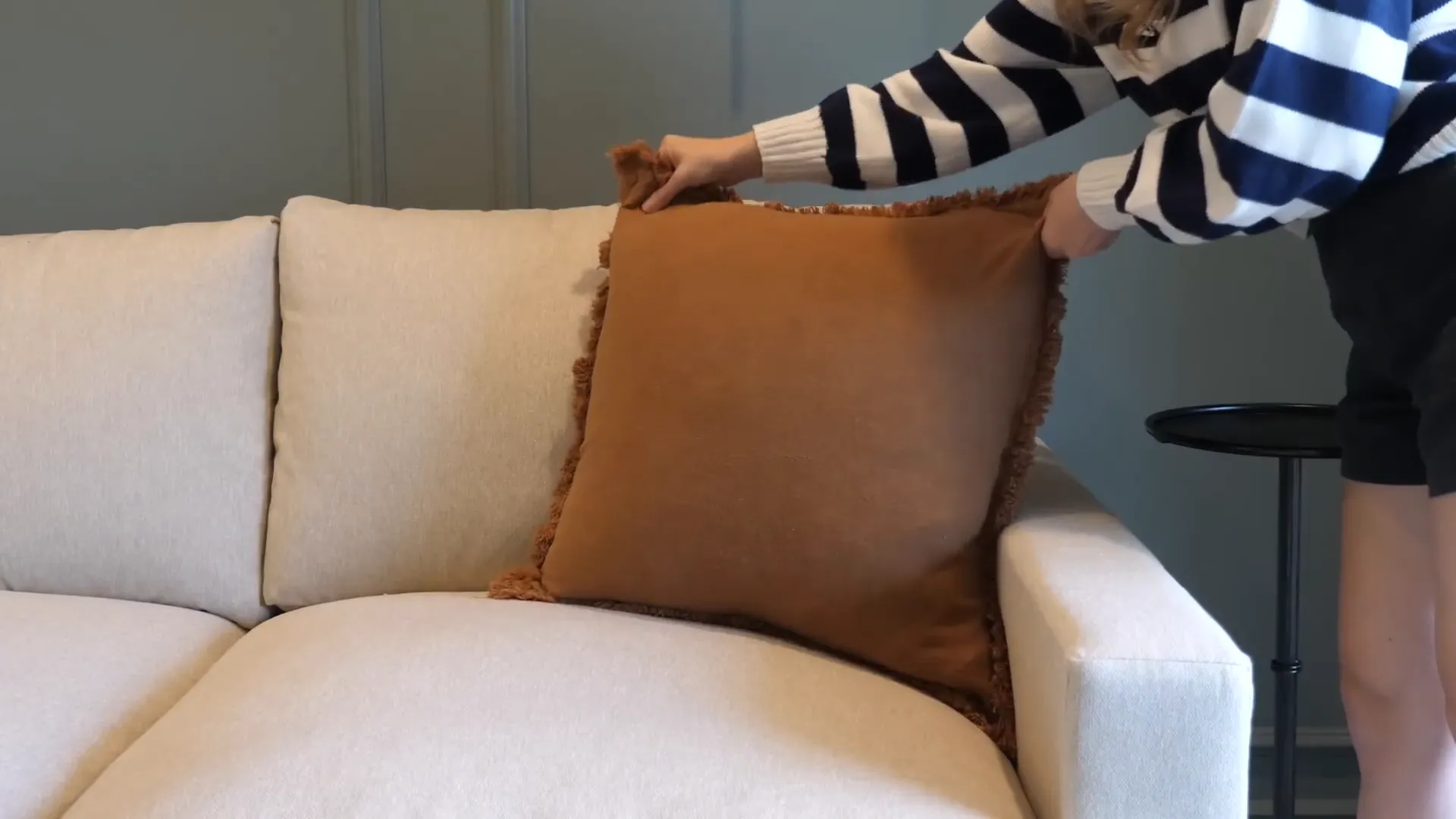 Arranging decorative pillows on the sofa